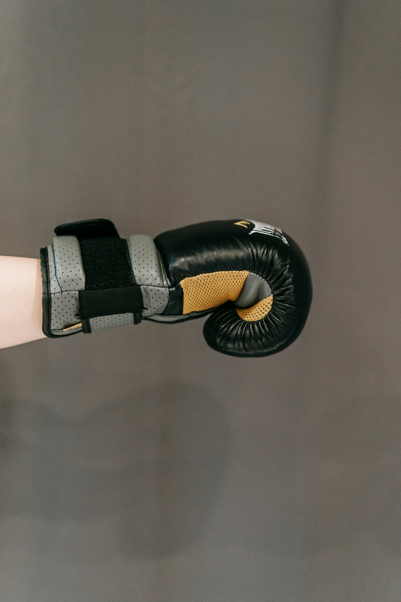 Unrecognizable boxer punching air during training